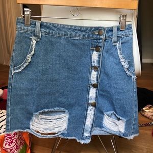 Distressed asymmetrical denim skirt with buttons
